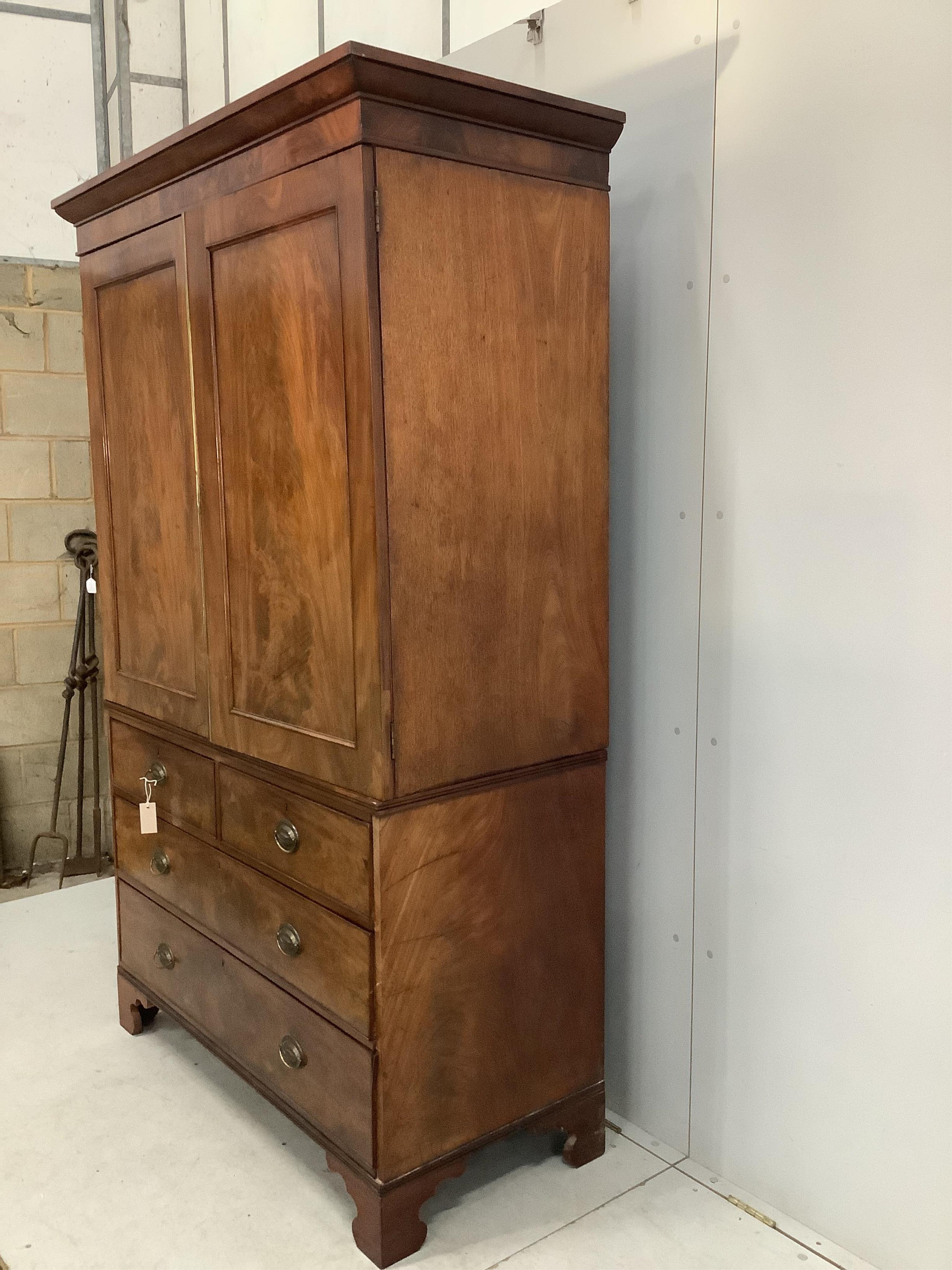 A George III mahogany linen press converted to a hanging wardrobe, width 130cm, depth 58cm, height 206cm. Condition - fair